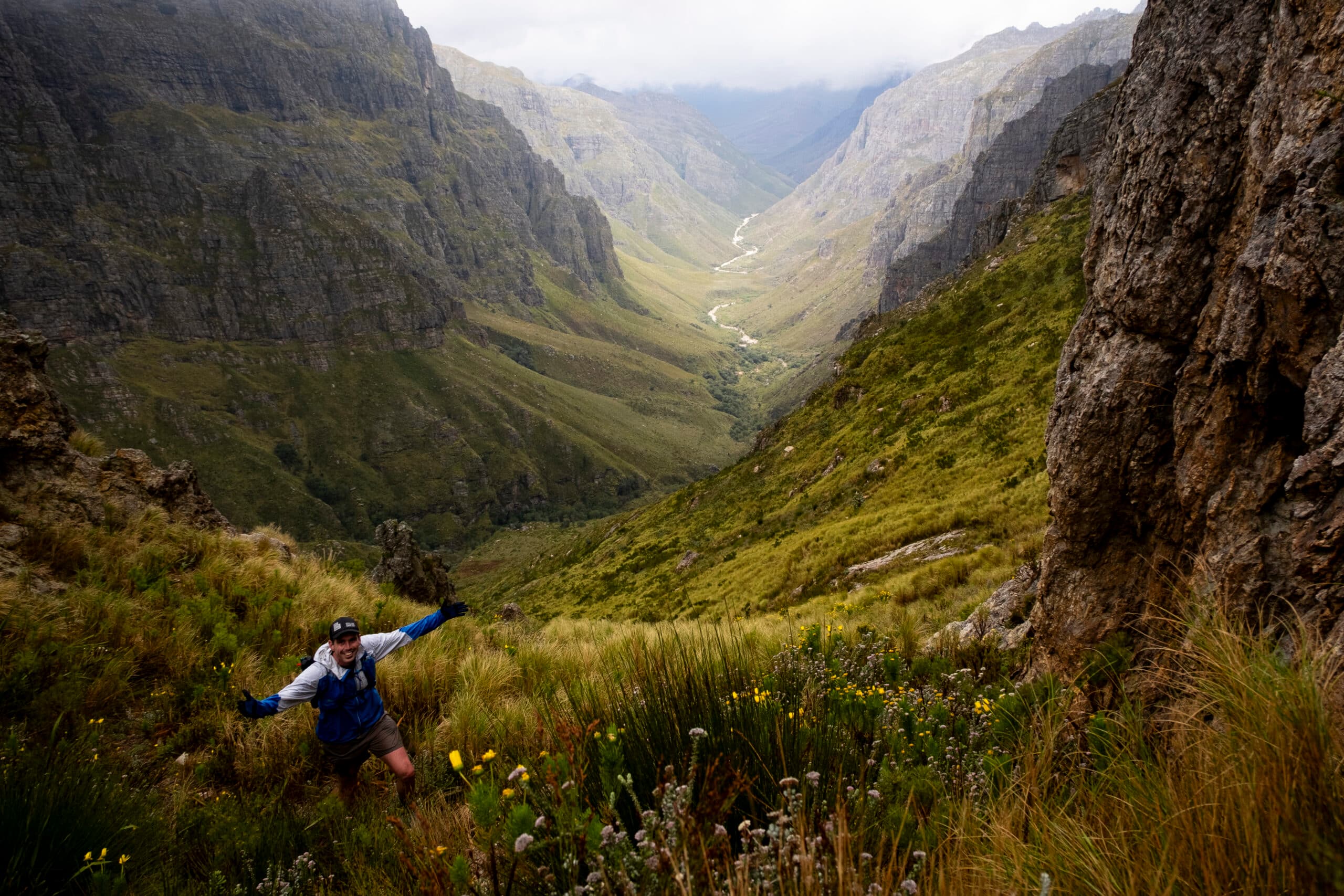 A trail runner on a mountain ridge with a beautiful view